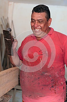 Carpenter places finishing details on a piece of furniture