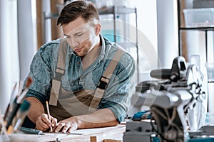 Carpenter planning work in workshop