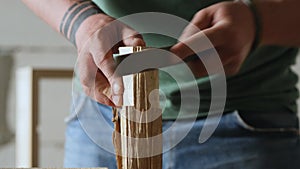 A carpenter processes a piece of wood with a file. the sound of carpentry tools. work with hand carpentry tools. art of