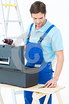 Carpenter removing tools from box