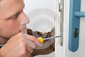 Carpenter Repairing Door Lock