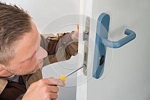 Carpenter Repairing Door Lock