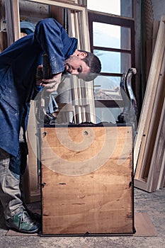 Carpenter restoring Wooden Furniture photo