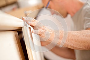 Carpenter's hand placing a board
