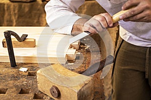 Carpenter`s hands working a piece of wood