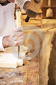 Carpenter`s hands working a piece of wood