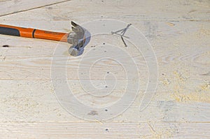 carpenter\'s tool. hammer and nails on a wooden floor.