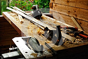 Carpenter`s tool on a workbench set outdoors