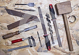 Carpenter`s tools on a wooden background