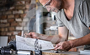 Carpenter`s workflow, carpenter looks at the drawings