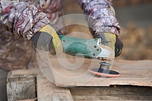 Carpenter sanding walnut wood