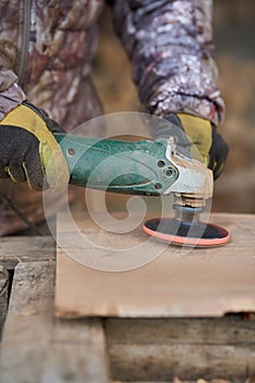 Carpenter sanding walnut wood