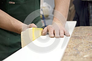 Carpenter sanding wood photo