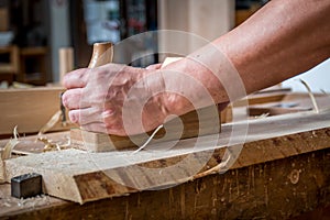 Carpenter sanding wood in the carpentry