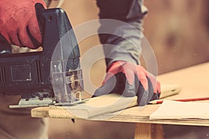 Carpenter sawing a board