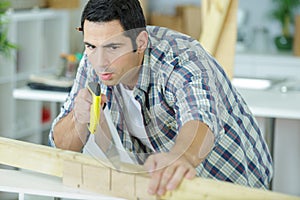 carpenter sawing wood