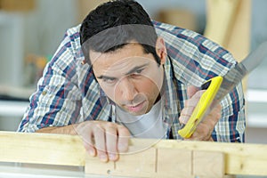 carpenter sawing wood