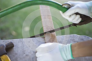 Carpenter sawing wood with traditional saws