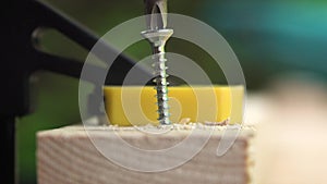 Carpenter saws a wooden bar with an electric saw