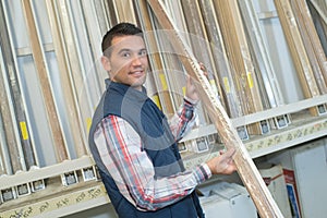 Carpenter selecting wood in hardware store