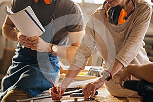 Carpenter Training Female Apprentice To Use Plane