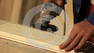 Carpenter smoothing surface of wood plank.