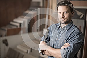 Carpenter standing with a chisel