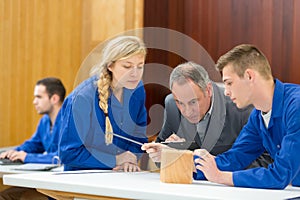 Carpenter with students in workshop