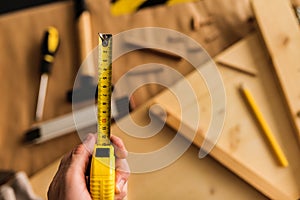 Carpenter with tape measure tool