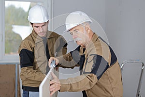 Carpenter teaching his trainee