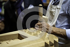 Carpenter tools, chisel. Close up carpenter`s hands that work with cutter