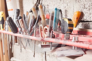Carpenter tools fixed on the wall at workshop