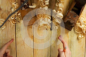 Carpenter tools on wood table background with sawdust. Copy space