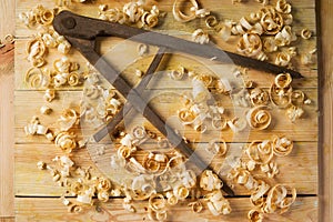 Carpenter tools on wood table background with sawdust. Copy space