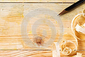 Carpenter tools on wood table background with sawdust. Copy space