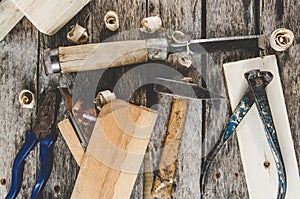 The carpenter tools on wooden bench, plane, chisel,mallet, tape measure, hammer, tongs, pliers