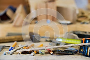 Carpenter tools on wooden table with sawdust