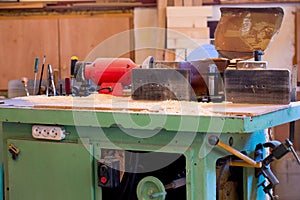 Carpenter tools on wooden table with sawdust