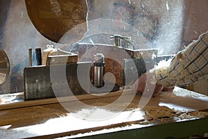 Carpenter tools on wooden table with sawdust. Circular Saw. Cutting a wooden plank