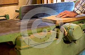 Carpenter tools on wooden table with sawdust. Circular Saw. Cutting a wooden plank