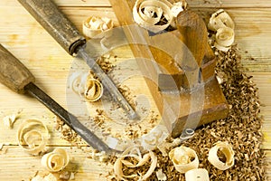 Carpenter tools on wooden table with sawdust. Craftperson workplace top view