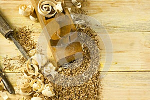 Carpenter tools on wooden table with sawdust. Craftperson workplace top view