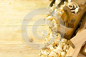 Carpenter tools on wooden table with sawdust. Craftperson workplace top view