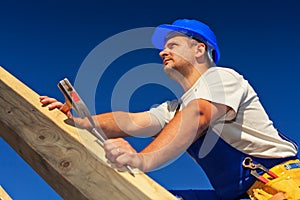 Carpenter on top of roof structure