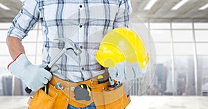 Carpenter torso with hammer against window