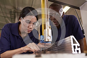 Carpenter Training Female Apprentice To Use Mechanized Saw