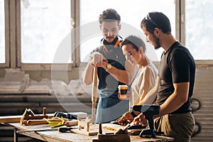 Carpenter Training Female Apprentice To Use Plane