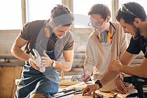 Carpenter Training Female Apprentice To Use Plane