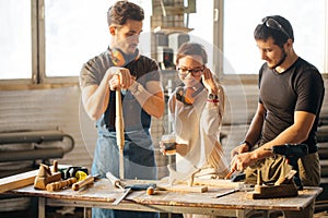 Carpenter Training Female Apprentice To Use Plane