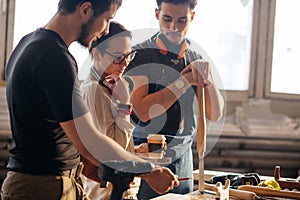 Carpenter Training Female Apprentice To Use Plane